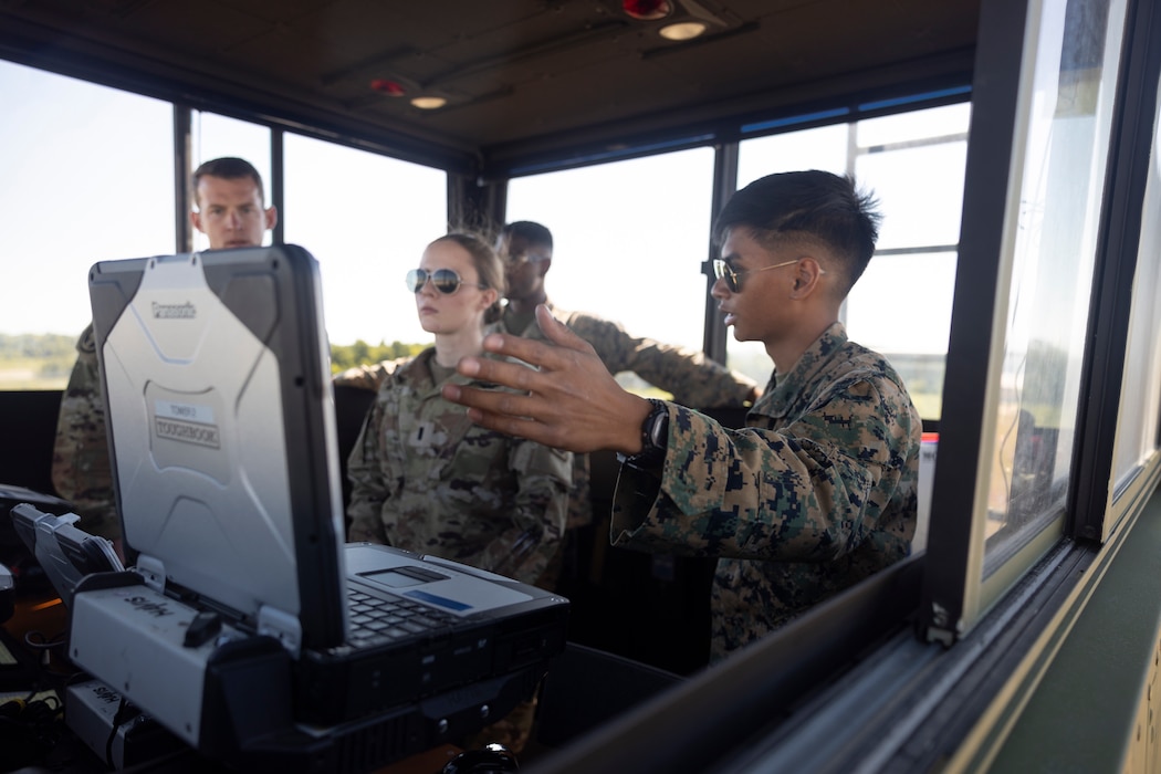U.S. Marine Corps Lance Cpl. Jaiden Martino, a native of Washington and a communication chief with Marine Air Control Squadron (MACS) 24, 4th Marine Aircraft Wing (MAW), demonstrates the functions of an Air Traffic Control tower during a Base Defense Zone (BDZ) exercise at Marine Corps Auxiliary Landing Field Bogue, North Carolina, June 11, 2024. Marines from 2nd Low-Altitude Air Defense (LAAD) Battalion, MACS-24 and Marine Wing Support Squadron (MWSS) 271 executed this exercise to enhance confidence and proficiency in BDZ operation (U.S. Marine Corps photo by Lance Cpl. Bryan Giraldo)