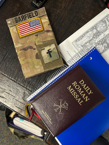 Symbolizing the dual mission of service to the military and God ,a Roman Missal lays next to Rev. Richard Barfield’s field notebook at Robins Air Force Base, Georgia.