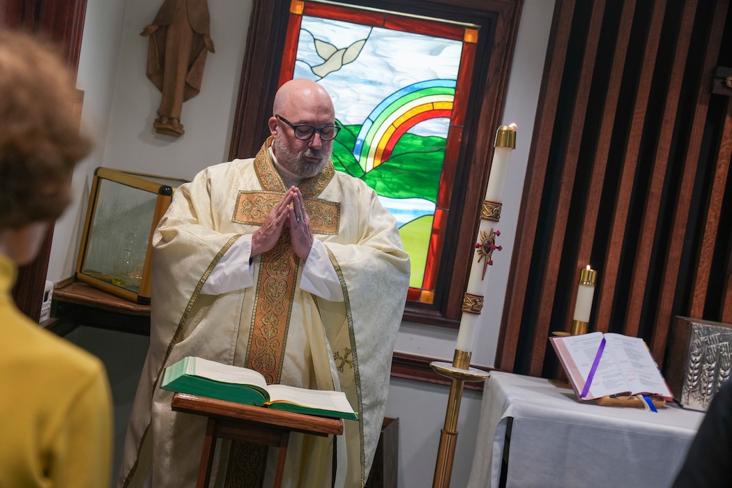Robins Catholic Rev. Richard Barfield performs daily mass with parishioners during daily mass in the Blessed Sacrament room at Robins Air Force Base, Georgia, April 23, 2025.