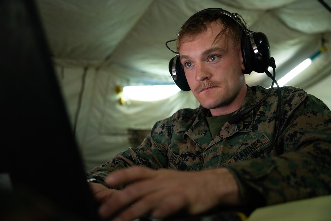 U.S. Marine Cpl. Michael Delaney, an air support operations operators with Marine Air Support Squadron 6, Marine Air Control Group 48, 4th Marine Aircraft Wing, receives air support requests during Virtual Flag 24 at Kirtland Air Force Base, New Mexico, Feb. 28, 2024. Virtual Flag provides theater-level, joint combat training in a real-time, virtual environment using air, land, space, cyber and maritime scenarios. Delaney is a native of Danbury, Connecticut. (U.S. Marine Corps photo by Cpl. Ujian Gosun)