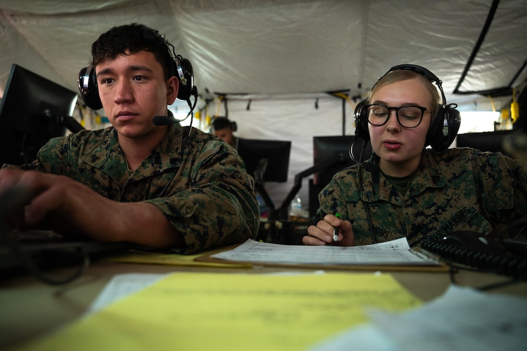 U.S. Marine Cpl. Jorge Arjon, left, and Cpl. Heather Lyons, both air support operations operators with Marine Air Support Squadron 6, Marine Air Control Group 48, 4th Marine Aircraft Wing, facilitate fixed wing aircraft operations during Virtual Flag 24 at Kirtland Air Force Base, New Mexico, Feb. 28, 2024. Virtual Flag provides theater-level, joint combat training in a real-time, virtual environment using air, land, space, cyber and maritime scenarios. Arjon is a native of Rancho Cucamonga, California, and Lyons is a native of Broadalbin, New York. (U.S. Marine Corps photo by Cpl. Ujian Gosun)