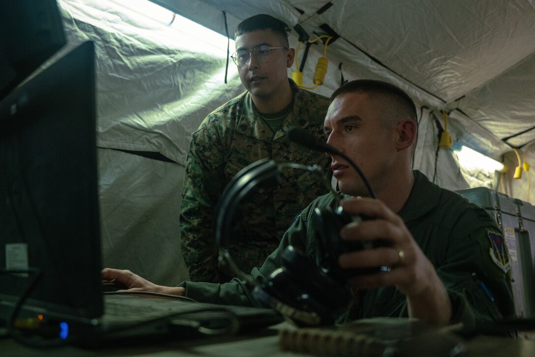 U.S. Marine Sgt. Joben Kitagawa, left, a tactical air defense systems technician with Marine Air Support Squadron 6, Marine Air Control Group 48, 4th Marine Aircraft Wing, establishes network connectivity with a U.S Airman during Virtual Flag 24 at Kirtland Air Force Base, New Mexico, Feb. 28, 2024. Virtual Flag provides theater-level, joint combat training in a real-time, virtual environment using air, land, space, cyber and maritime scenarios. Kitagawa is a native of San Diego, California. (U.S. Marine Corps photo by Cpl. Ujian Gosun)