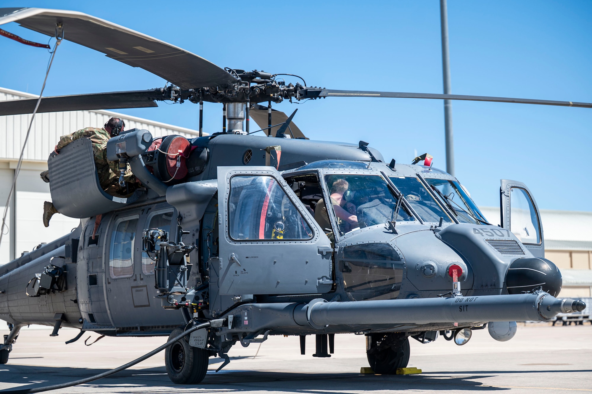 U.S. Air Force Airmen assigned to the 55th Rescue Generation Squadron inspect an HH-60W Jolly Green II helicopter during routine servicing to maintain mission capability at Davis-Monthan Air Force Base, Arizona, April 23, 2025. Air Force maintainers keep the squadron mission-ready, ensuring every aircraft is fully operational and capable of executing rescue missions when every second counts. (U.S. Air Force photo by Airman Samantha Melecio)