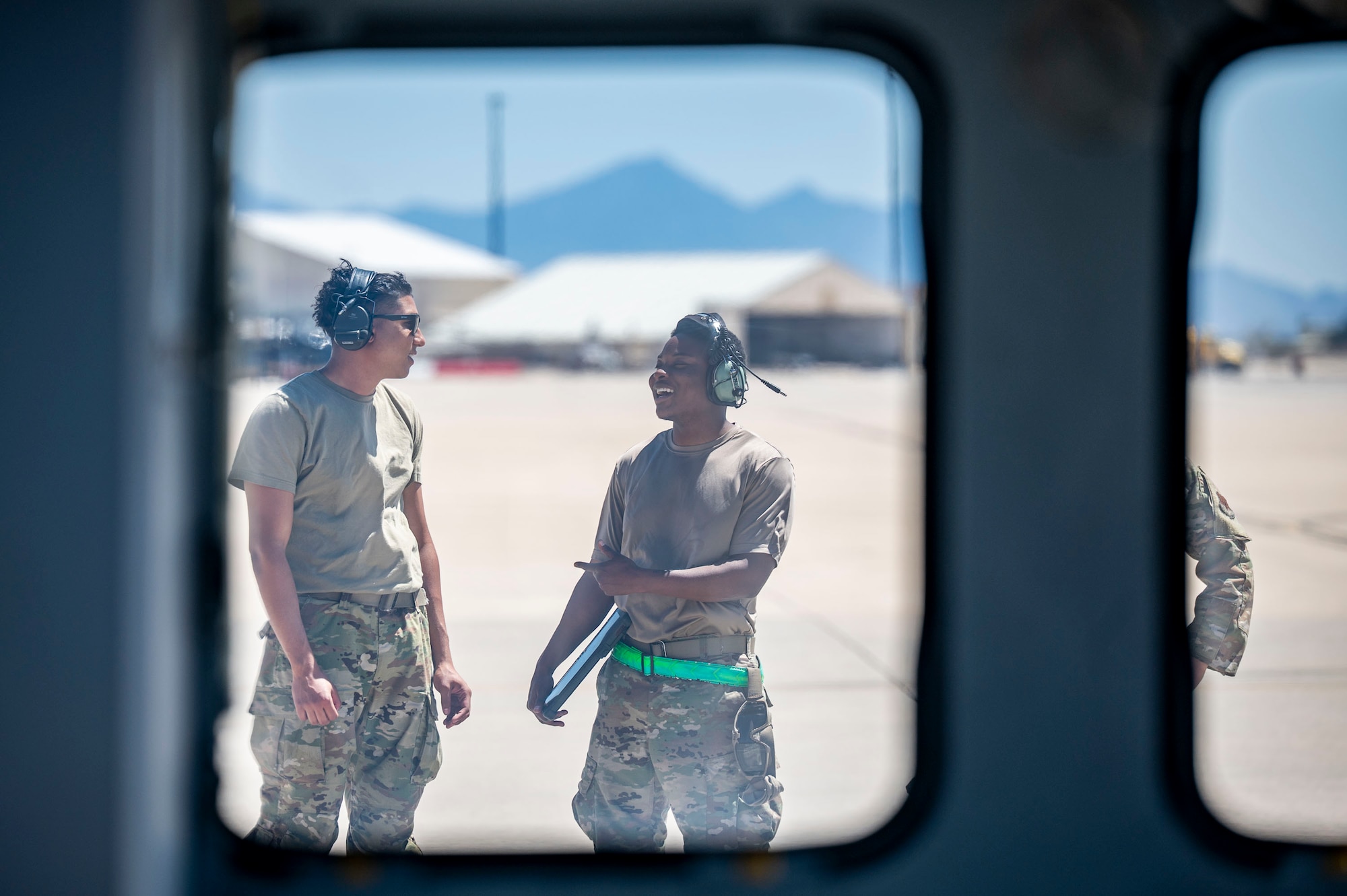 U.S. Air Force Airmen assigned to the 55th Rescue Generation Squadron discuss operations while conducting routine maintenance checks on an HH-60W Jolly Green II helicopter to maintain mission readiness at Davis-Monthan Air Force Base, Arizona, April 23, 2025. The HH-60W “Jolly Green II” is the U.S. Air Force’s premier combat rescue helicopter, designed to perform personnel recovery missions in contested and hostile environments. (U.S. Air Force photo by Airman Samantha Melecio)