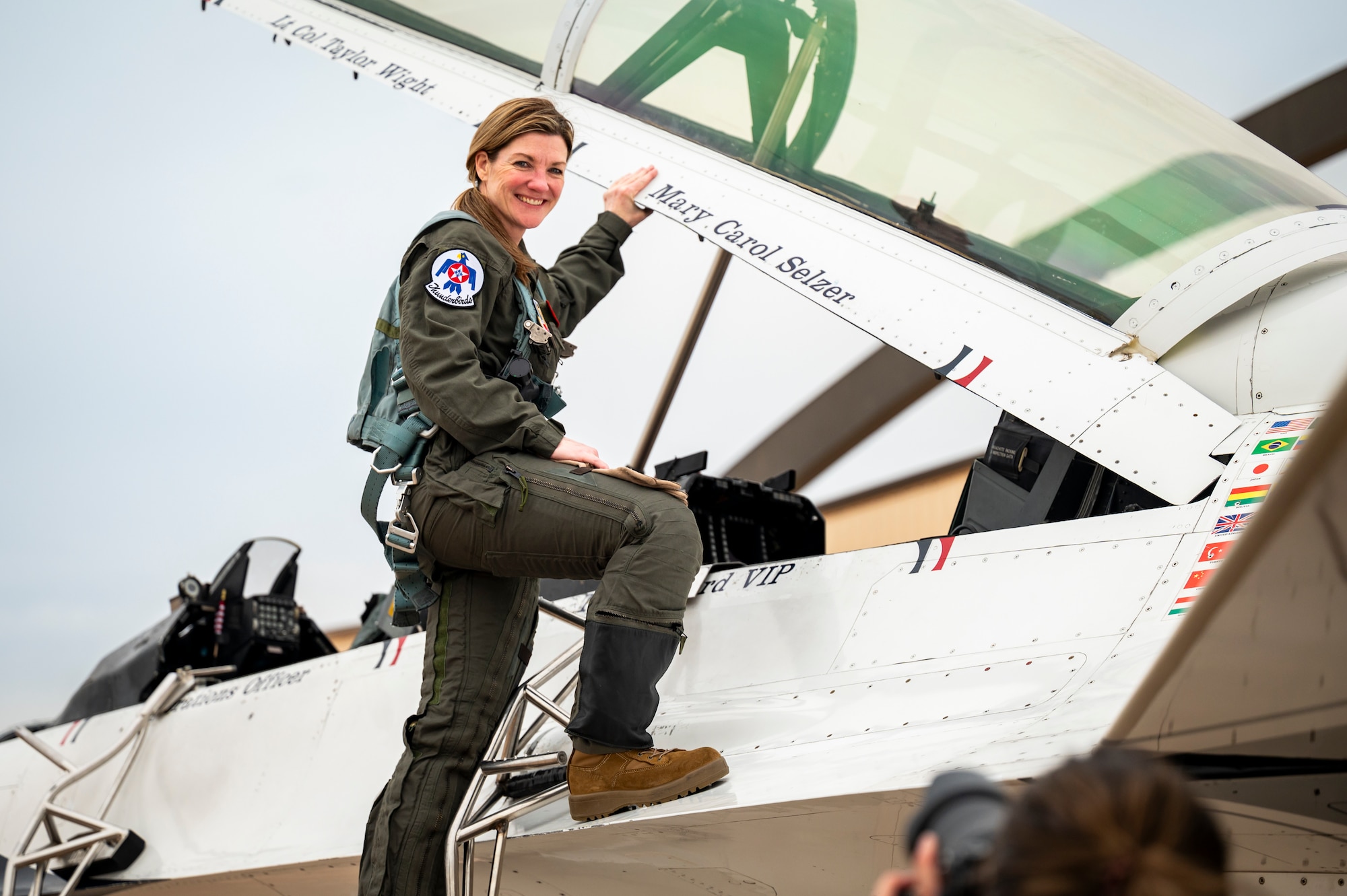 Cari Selzer, Hometown Hero participant, poses for a picture on a F-16 Fighting Falcon, assigned to the U.S. Air Force Air Demonstration Squadron "Thunderbirds", before an incentive flight at Dyess Air Force Base, Texas, April 18, 2025. Despite her demanding career and volunteer commitments, Selzer is a devoted wife and mother of five, demonstrating that dedication to service can coexist with a fulfilling family life. (U.S. Air Force photo by Staff Sgt. Leon Redfern)