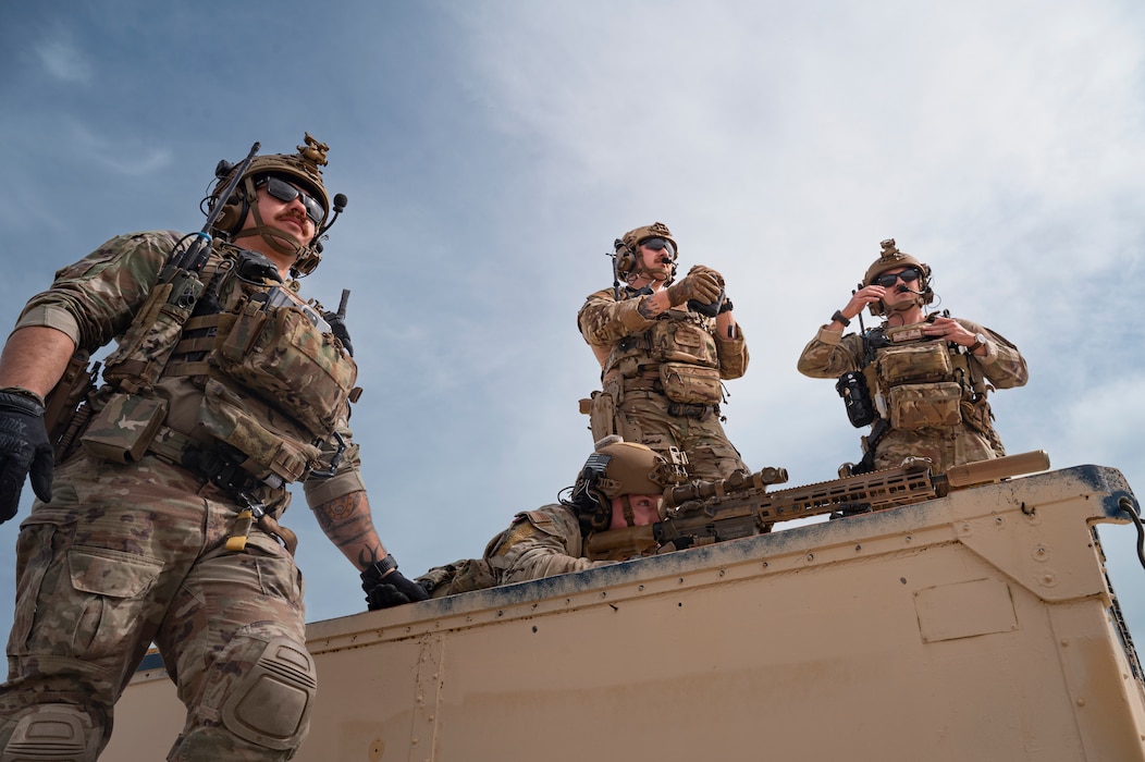 Airman aims down sniper rifle scope