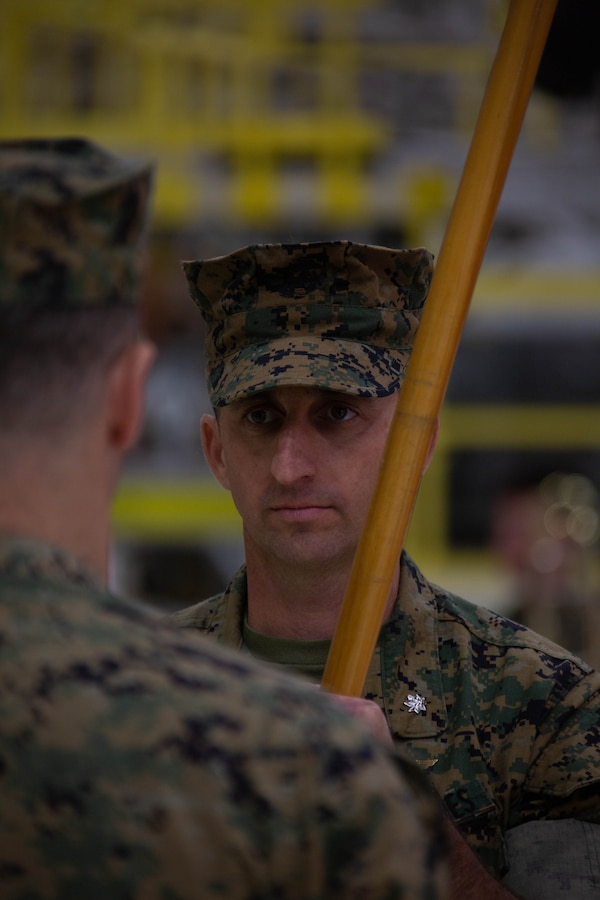 U.S. Marine Corps Lt. Col. David A. Goodman, incoming commanding officer, Marine Aviation Logistics Squadron 49 (MALS-49), Marine Aircraft group 49, 4th Marine Air Wing, receives the battalion colors during the MALS-49 change of command ceremony on Marine Corps Air Station New River, in Jacksonville, North Carolina, April 12, 2025. The change of command ceremony represents the transfer of responsibility, authority, and accountability from the outgoing commanding officer to the incoming commanding officer. (U.S. Marine Corps photo by Lance Cpl. Hunter Brock)