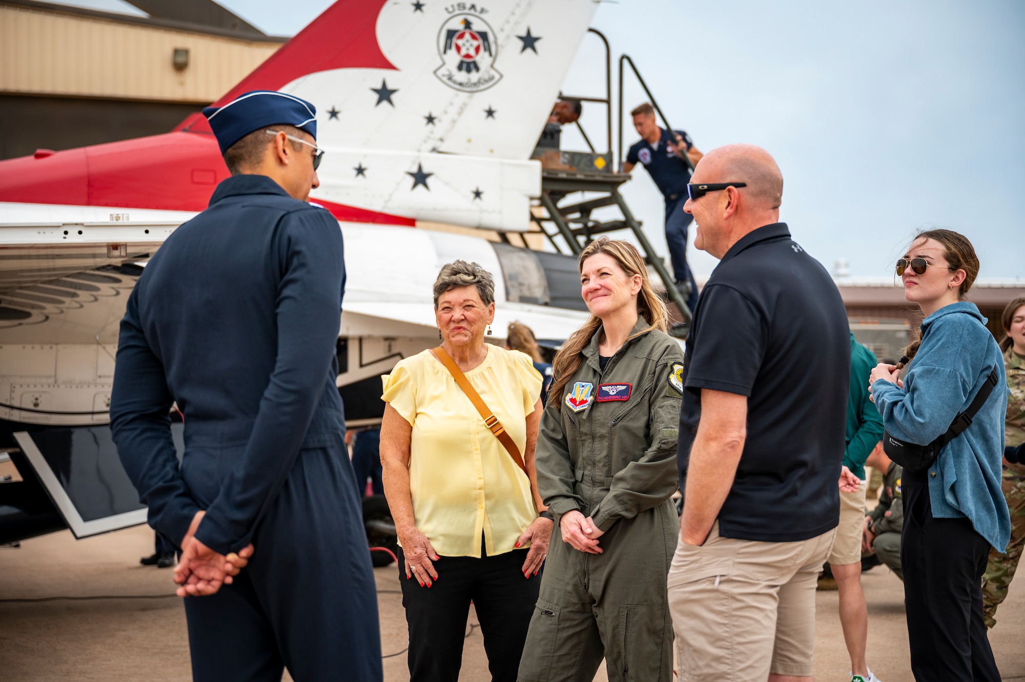 U.S. Air Force Lt. Col. Taylor Wight, left, Thunderbird Seven, Director of Operations for the U.S. Air Force Air Demonstration Squadron "Thunderbirds", talks to Cari Selzer, right, Hometown Hero participant, and her family, before an incentive flight at Dyess Air Force Base, Texas, April 18, 2025. Selzer actively volunteers at the Union Gospel Mission in Fort Worth, serving meals to the homeless, organizing group outings for her colleagues, and creating special events for families in need. (U.S. Air Force photo by Staff Sgt. Leon Redfern)