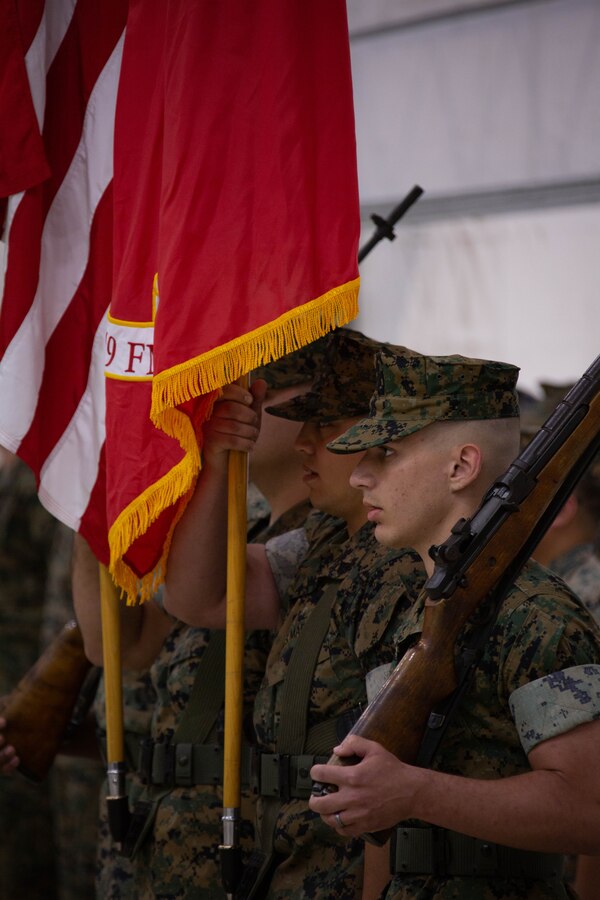 The color guard with Marine Aviation Logistics Squadron 49 (MALS-49), Marine Aircraft Group 49, 4th Marine Air Wing, stands at the position of attention during the MALS-49 change of command ceremony on Marine Corps Air Station New River, in Jacksonville, North Carolina, April 12, 2025. The change of command ceremony represents the transfer of responsibility, authority, and accountability from the outgoing commanding officer to the incoming commanding officer. (U.S. Marine Corps photo by Lance Cpl. Hunter Brock)
