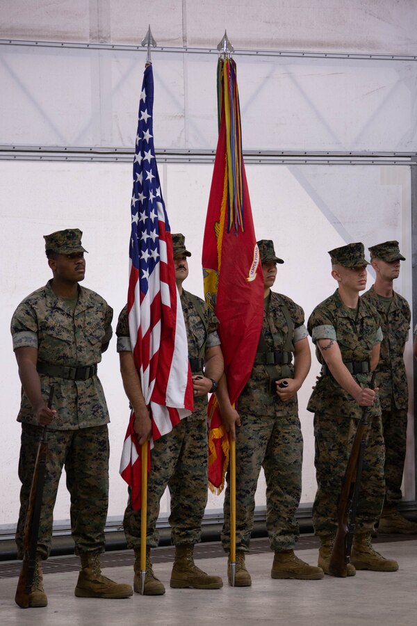 The color guard with Marine Aviation Logistics Squadron 49 (MALS-49), Marine Aircraft Group 49, 4th Marine Air Wing, stands at parade rest during the MALS-49 change of command ceremony on Marine Corps Air Station New River, in Jacksonville, North Carolina, April 12, 2025. The change of command ceremony represents the transfer of responsibility, authority, and accountability from the outgoing commanding officer to the incoming commanding officer. (U.S. Marine Corps photo by Lance Cpl. Hunter Brock)