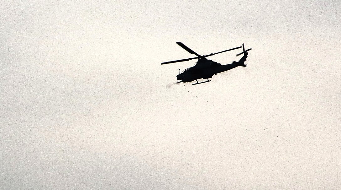 A Cobra AHT-1Z from The Marine Light Attack Helicopter Squadron 773 (HMLA-773), fires its gatling guns at targets during a daytime aerial gunnery mission on range 59C at Fort Dix.  The Marine Light Attack Helicopter Squadron 773 (HMLA-773) is a United States Marine Corps helicopter squadron. The squadron is based at Joint Base McGuire–Dix–Lakehurst, NJ and falls under the command of Marine Aircraft Group 49 (MAG-49).  (Images provided by the Fort DIX USASA Training Division / Steven Roussel)