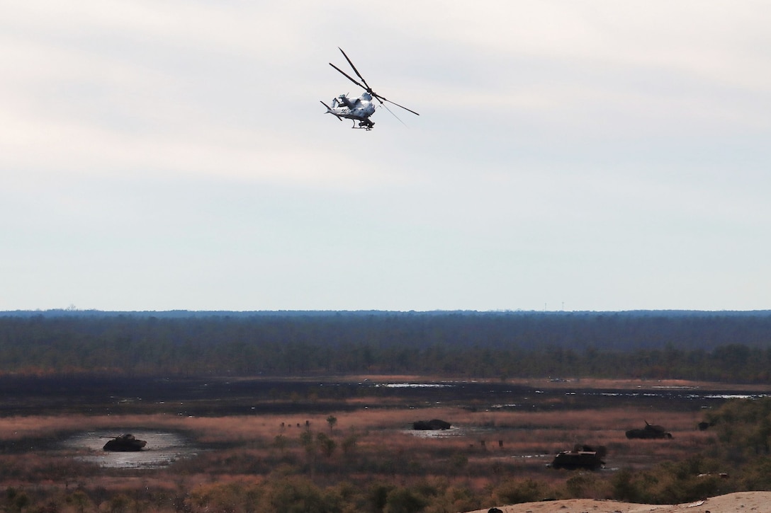 A Cobra AHT-1Z scouts targets at range 59C for day/night aerial gunnery missions with a full contingent of 40 mm rockets and 20mm gatling gun rounds. The squadron is based at Joint Base McGuire–Dix–Lakehurst, NJ and falls under the command of Marine Aircraft Group 49 (MAG-49).  (Images provided by the Fort DIX USASA Training Division / Steven Roussel)