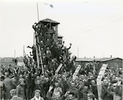 Newly liberated prisoners of the Allach concentration camp celebrate their liberation near Dachau, Germany, April 30, 1945.