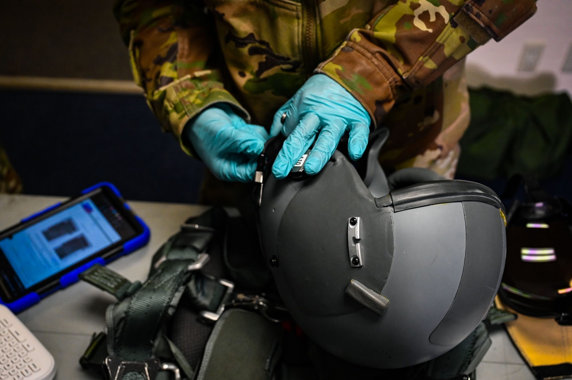 U.S. Air Force Airman Senior Airman Jacob Gomez, 9th Expeditionary Bomb Squadron aircrew flight equipment technician, performs an inspection on a HGU 55P helmet before the aircrew takes off for a Bomber Task Force mission at Misawa Air Base, Japan, April 21, 2025. The Bomber Task Force missions conducted by USSTRATCOM help ensure global security by proving the ability to show deterrence in various locations, while also enhancing the military readiness of allied and partner forces. (U.S. Air Force photo by Airman 1st Class Mattison Cole)