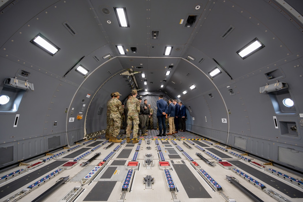 Airmen standing inside of airplane