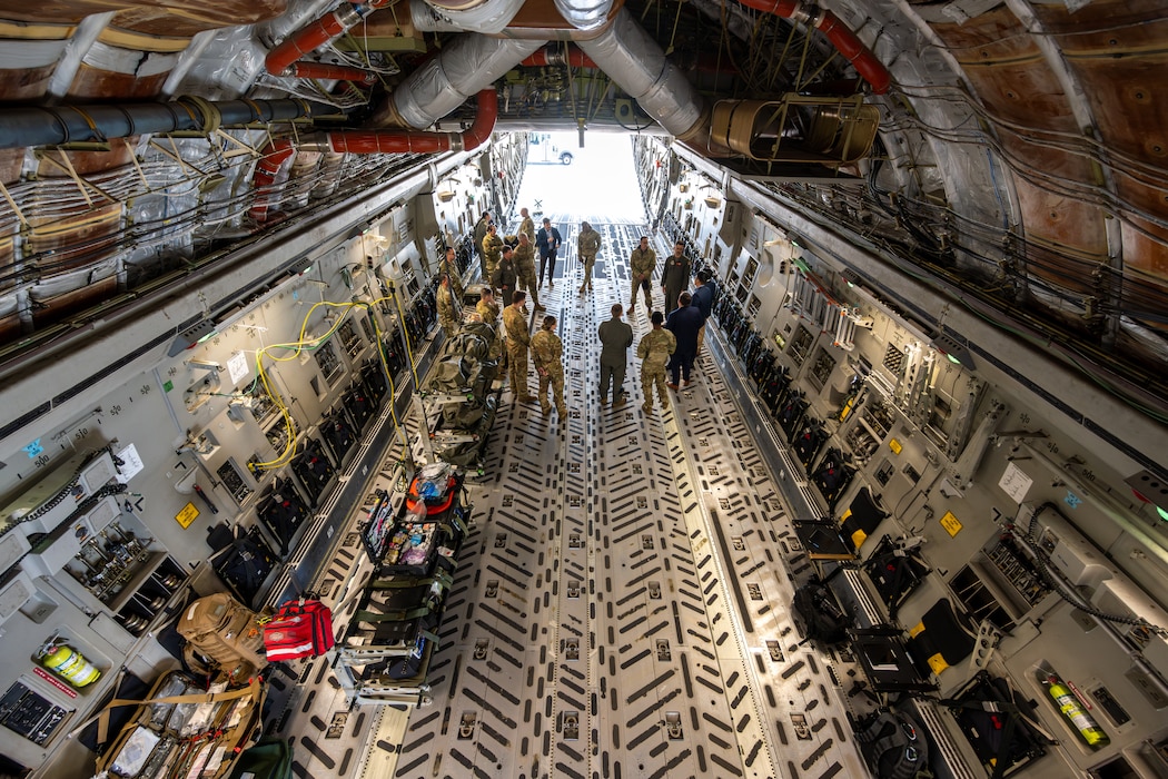 Airmen stand inside C-17 aircraft