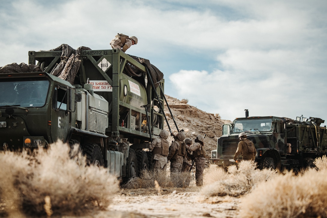 U.S. Marines with Combat Logistics Battalion 7, 1st Marine Logistics Group, I Marine Expeditionary Force, take down camouflage netting during a Tactical Logistics Operations Course as part of Integrated Training Exercise 1-25 at Range 800, Marine Corps Air-Ground Combat Center, Twentynine Palms, California, Jan. 30, 2025. TLOC tests the logistics element’s ability to sustain operations in a contested environment by integrating ground logistics capabilities to ensure mission success. ITX enhances the lethality, autonomy and decision-making of the MAGTF by creating a challenging and realistic training environment. (U.S. Marine Corps photo by Lance Cpl. Richard PerezGarcia)
