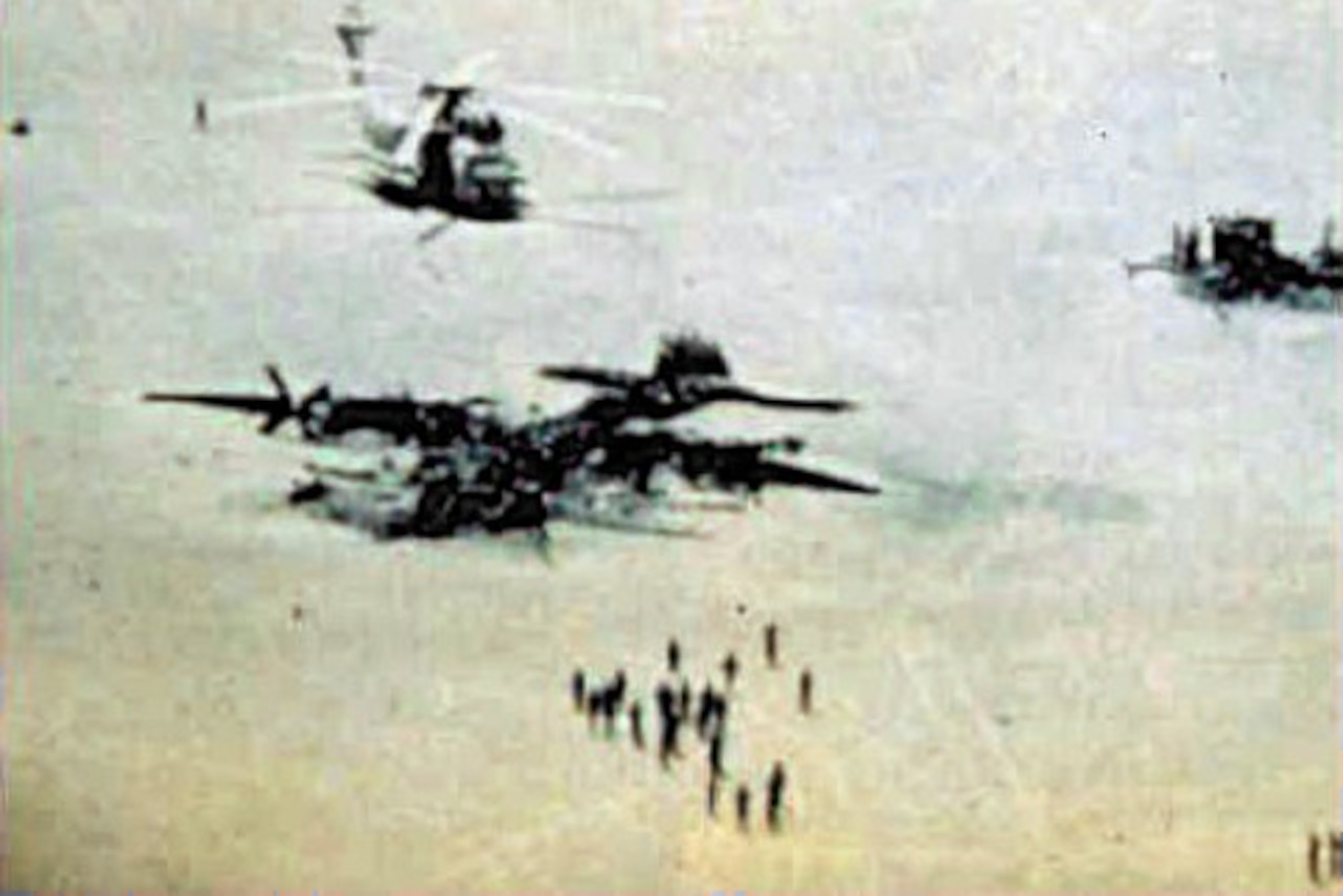 A helicopter and a wrecked aircraft are shown.