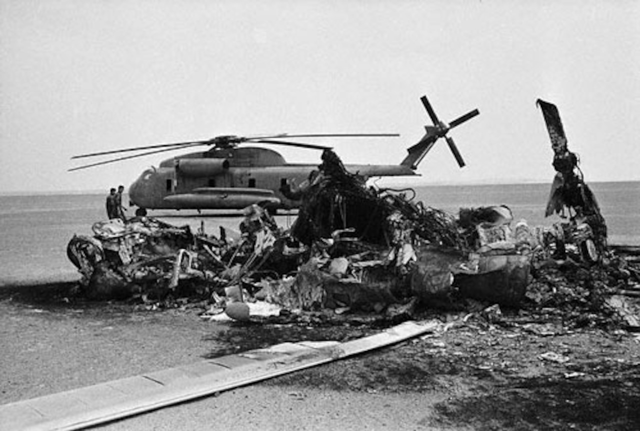 A helicopter and a wrecked helicopter are shown.