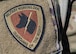 A 5th Security Forces Squadron military working dog patch is worn by U.S. Air Force Staff Sgt. Sandra Ohta-Jones Harris, 5SFS military working dog handler, at Minot Air Force Base, North Dakota, April 21, 2025. The 5SFS’s military working dogs are trained to support a variety of operations, including drug detection, explosive ordnance detection and security patrols. (U.S. Air Force photo by Senior Airman Kyle Wilson)