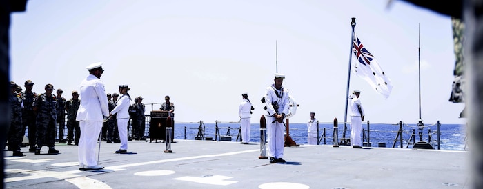 Royal Australian Navy sailors aboard the Hobart-class guided-missile destroyer HMAS Sydney (DDG 42) hold a ceremony commemorating Anzac day, which was attended by Sailors from the Independence-variant littoral combat ship USS Omaha (LCS 12), April 25, 2025.