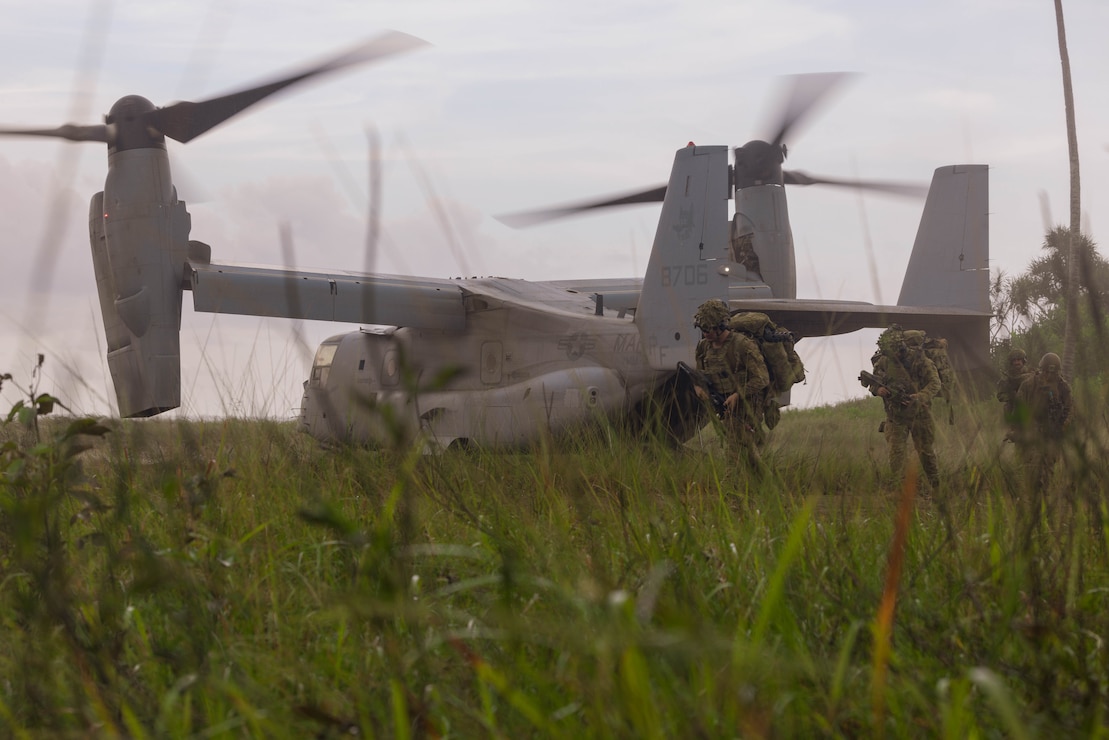 Australian soldiers with 5th/7th Battalion Royal Australian Regiment step off an MV-22B Osprey with Marine Medium Tiltrotor Squadron 364, 3rd Marine Aircraft Wing, during an air insert from Puerto Princesa, Palawan, Philippines, to Rizal in support of Exercise Balikatan 25, April 23, 2025.
