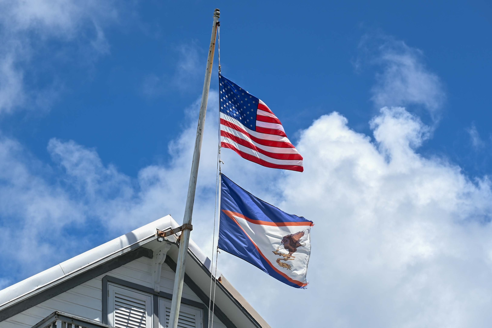 The American and American Samoa flags fly in tandem at the Governor’s Mansion in Pago Pago, American Samoa, April 16, 2025. The flags symbolize the enduring partnership and shared values between American Samoa and the United States. (U.S. Air Force photo by Senior Airman Melody Bordeaux)