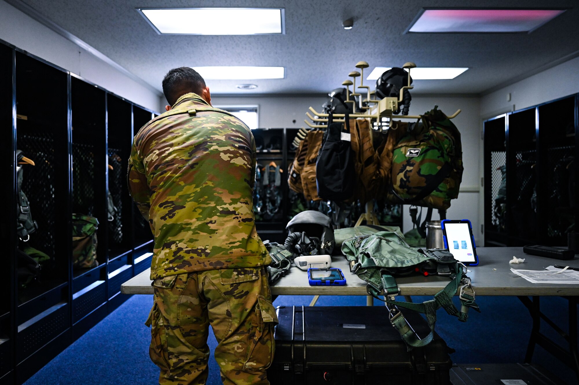 U.S. Air Force Senior Airman Jacob Gomez, 9th Expeditionary Bomb Squadron aircrew flight equipment technician, performs an inspection on a PCU 15P harness and HGU 55P helmet before the aircrew takes off for a Bomber Task Force mission at Misawa Air Base, Japan, April 21, 2025. The 9th EBS AFE members follow all safety precautions during equipment inspections to ensure it is operable and up to par. BTF 25-2 provides opportunities to train and work with our allies and partners in joint and combined operations. (U.S. Air Force photo by Airman 1st Class Mattison Cole)