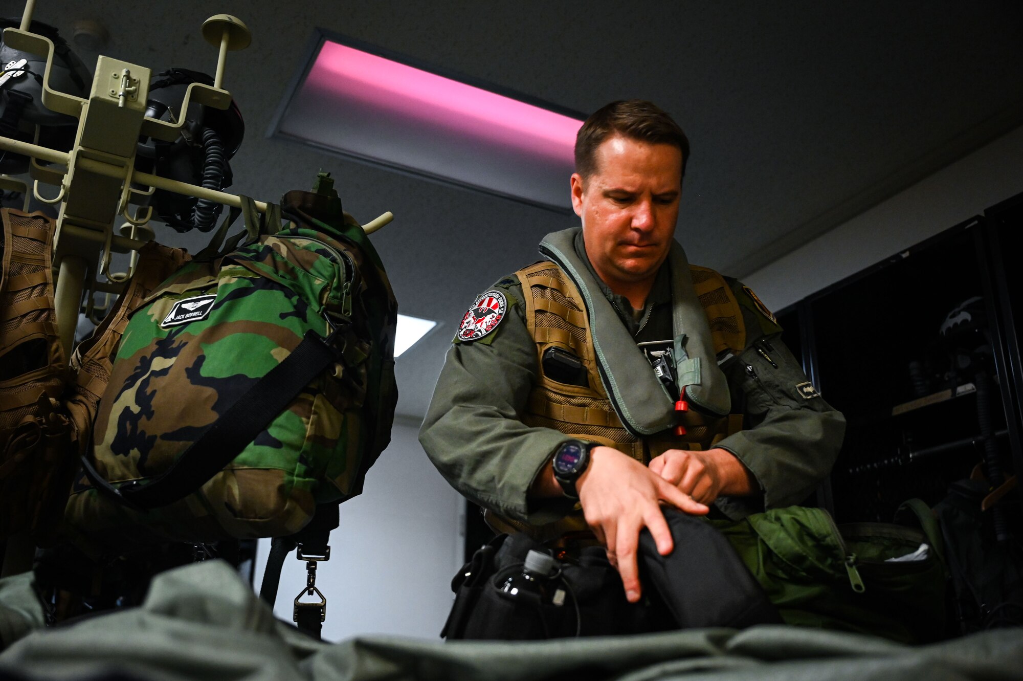 U.S. Air Force Lt. Col. Christopher Travelstead, 9th Expeditionary Bomb Squadron director of operations, packs his HGU 55P helmet before taking off for a Bomber Task Force mission at Misawa Air Base, Japan, April 21, 2025. The BTF mission provides opportunities to train and work with our allies and partners in joint and combined operations to discourage aggression and maintain peace and stability in the region and beyond. (U.S. Air Force photo by Airman 1st Class Mattison Cole)