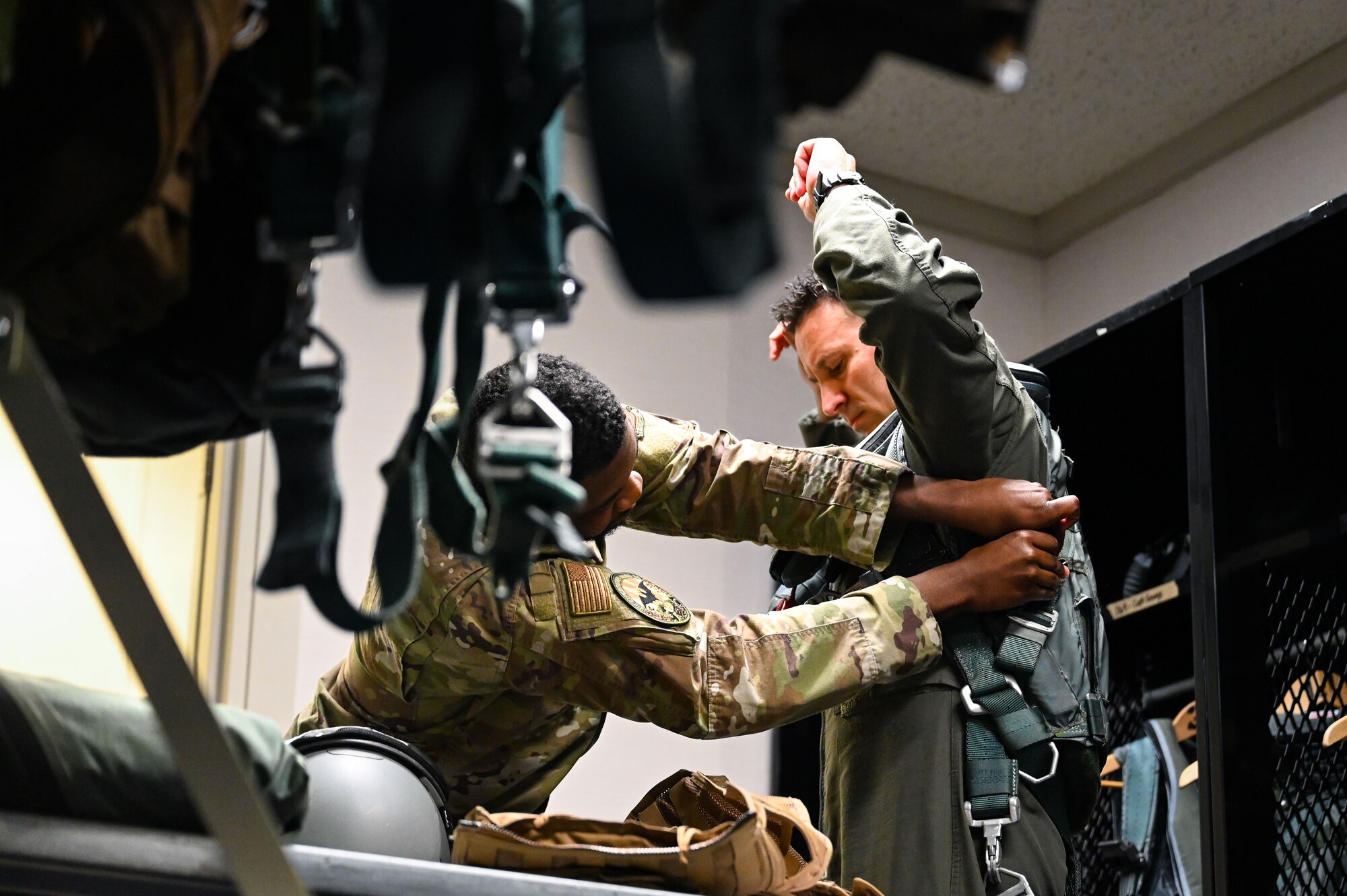 (From left to right) U.S. Air Force Airman 1st Class Juwan Johnson, 9th Expeditionary Bomb Squadron aircrew flight equipment technician, assists Maj. Brandon Felley, 9 EBS weapons systems officer, with his PCU 15P harness before the aircrew takes off for a Bomber Task Force mission at Misawa Air Base, Japan, April 21, 2025. The BTF mission provides opportunities to train and work with our allies and partners in joint and combined operations to discourage aggression and maintain peace and stability in the region and beyond. (U.S. Air Force photo by Airman 1st Class Mattison Cole)
