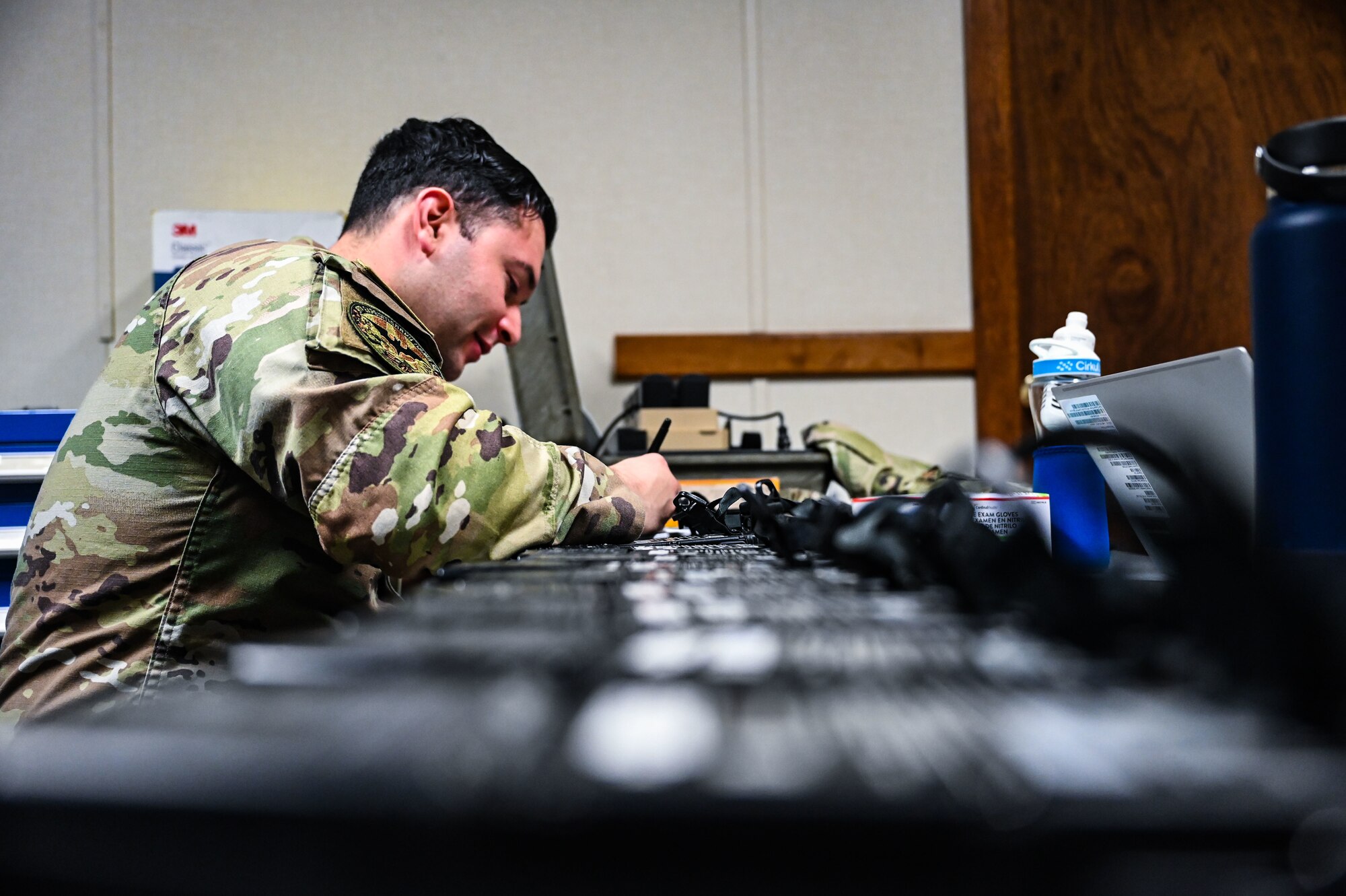 U.S. Air Force Staff Sgt. Eric DeLaMater, 9th Expeditionary Bomb Squadron aircrew flight equipment supervisor, checks the serial numbers for each combat survivor evader locator system radio and performs GPS fixes before the aircrew takes off for a Bomber Task Force mission at Misawa Air Base, Japan, April 21, 2025. The Bomber Task Force missions conducted by USSTRATCOM help ensure global security by proving the ability to show deterrence in various locations, while also enhancing the military readiness of allied and partner forces. (U.S. Air Force photo by Airman 1st Class Mattison Cole)