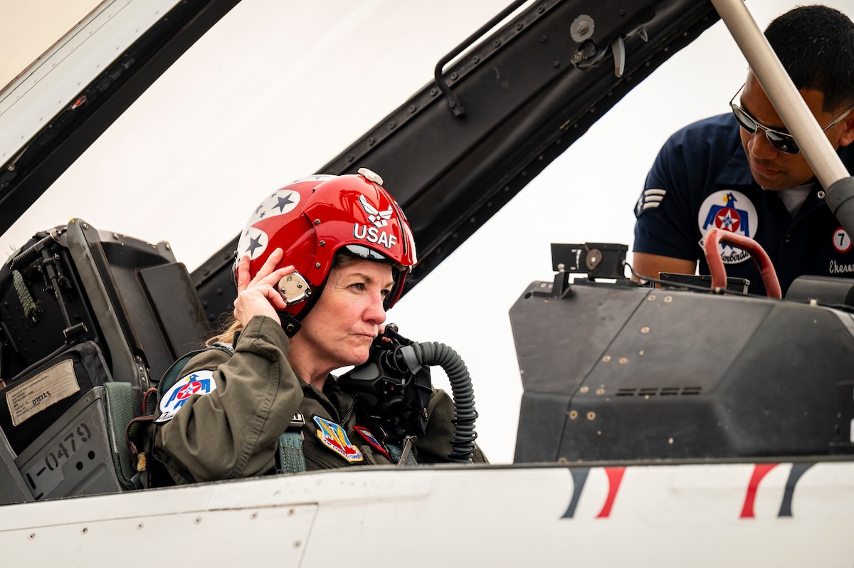 Cari Selzer, Hometown Hero participant, dawns flight equipment in the cockpit of a F-16 Fighting Falcon, with assistance from U.S. Air Force Senior Airman Jeremiah Ekeroma, an Aircraft Fuel Systems technician for the U.S. Air Force Air Demonstration Squadron "Thunderbirds", during an incentive flight at Dyess Air Force Base, Texas, April 18, 2025. Selzer is a dedicated nurse practitioner with 30 years of experience. Her unwavering commitment to serving others, both locally and internationally, spans from life-saving emergency interventions, to consistent volunteer work, and nursing education. Her actions and career embodies the spirit of compassion and service. (U.S. Air Force photo by Staff Sgt. Leon Redfern)
