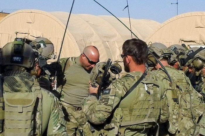 Chaplain Richard Barfield prays with U.S. Army Special Forces before a mission in Afghanistan, 2012.
