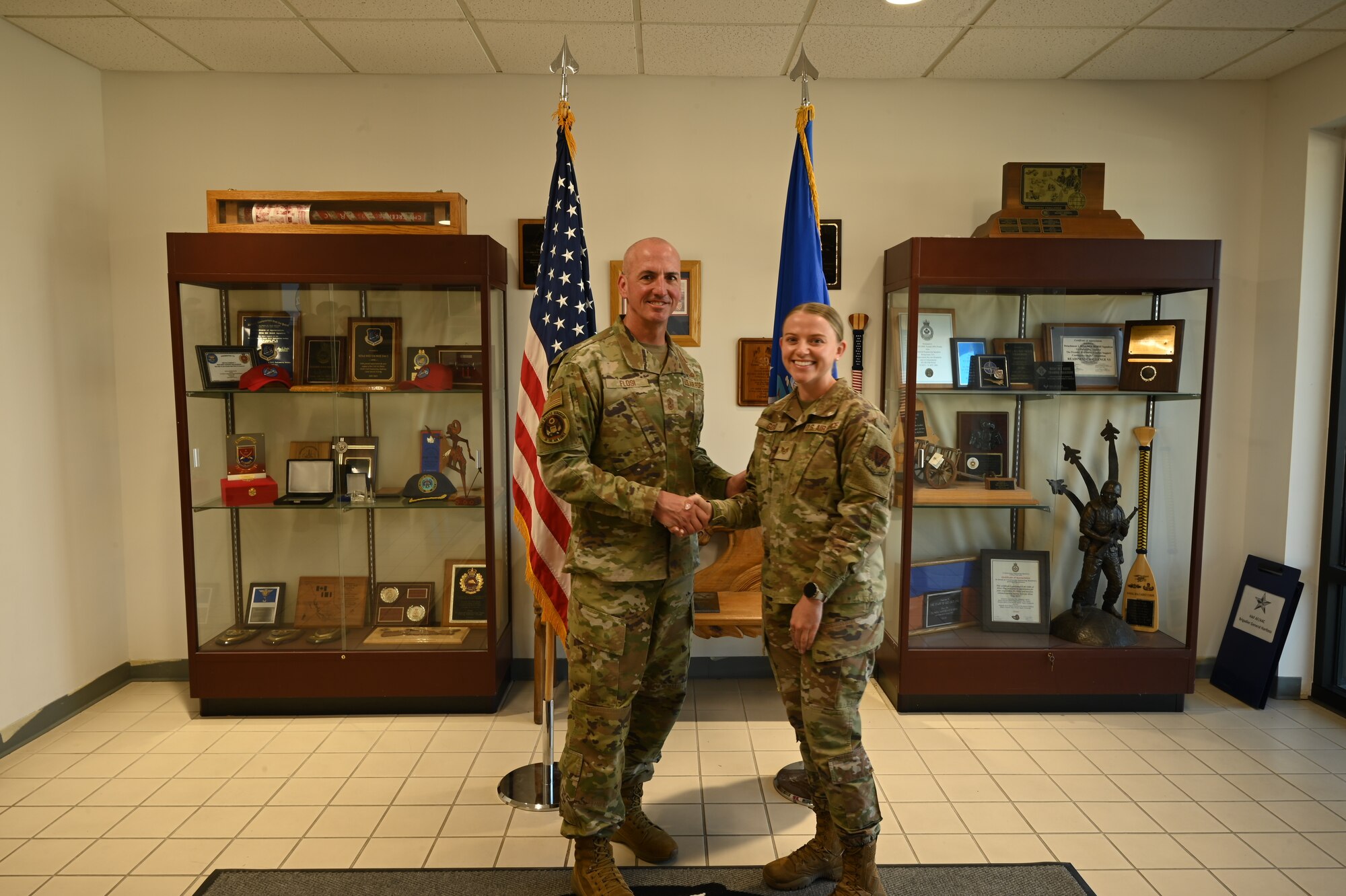 Chief Master Sgt. of the Air Force David Flosi coins Staff Sgt. Kristen Good, Command Chief Executive Assistant assigned to the 325th Fighter Wing, after a tour at Tyndall Air Force Base, Florida, April 16, 2025. The 22nd Air Task Force is participating in rigorous exercises and diverse training programs to ensure Airmen are fully prepared to execute assigned missions. (U.S. Air Force photo by Senior Master Sgt. Shelise Harmon).