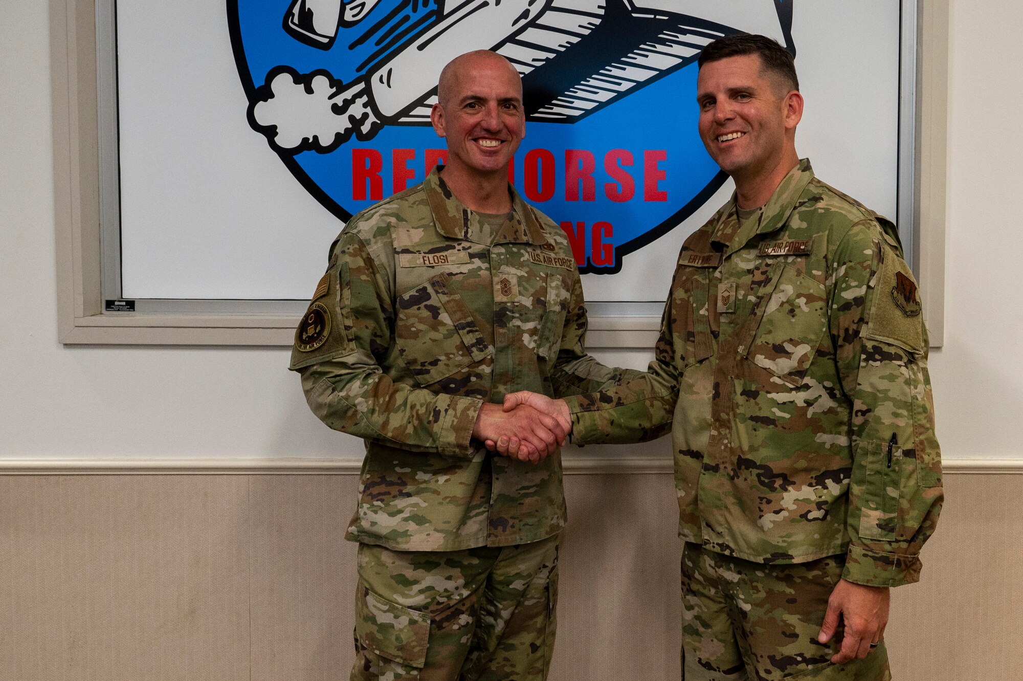 Chief Master Sgt. of the Air Force David Flosi coins Master Sgt. David Ertwine, section chief of infrastructure contingency training assigned to the 801st Red Horse Training Squadron, after a tour at Tyndall Air Force Base, Florida, April 16, 2025. The 22nd Air Task Force is participating in rigorous exercises and diverse training programs to ensure Airmen are fully prepared to execute assigned missions. (U.S. Air Force photo by Airman 1st Class Samantha Thorn).