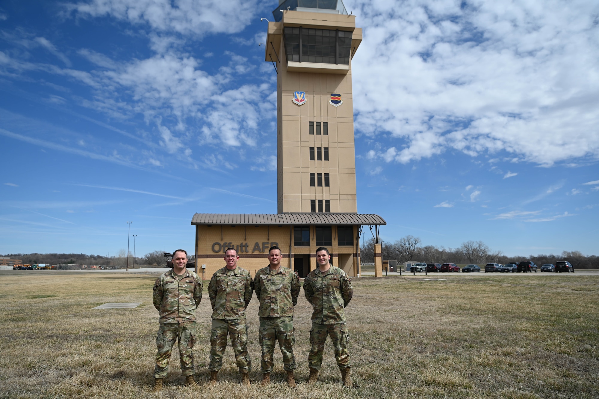 Enlisted leaders assigned to 55th Operations Support Squadron's air traffic control pose for a photo outside the control tower on the Offutt airfield March 26, 2025. Left to right: Master Sgt. Dusty Hildreth, Master Sgt. Michael Jaeger, Senior Master Sgt. Daniel Sluss, and Tech. Sgt. Andrew Kalina. (U.S. Air Force photo by Daniel Martinez)