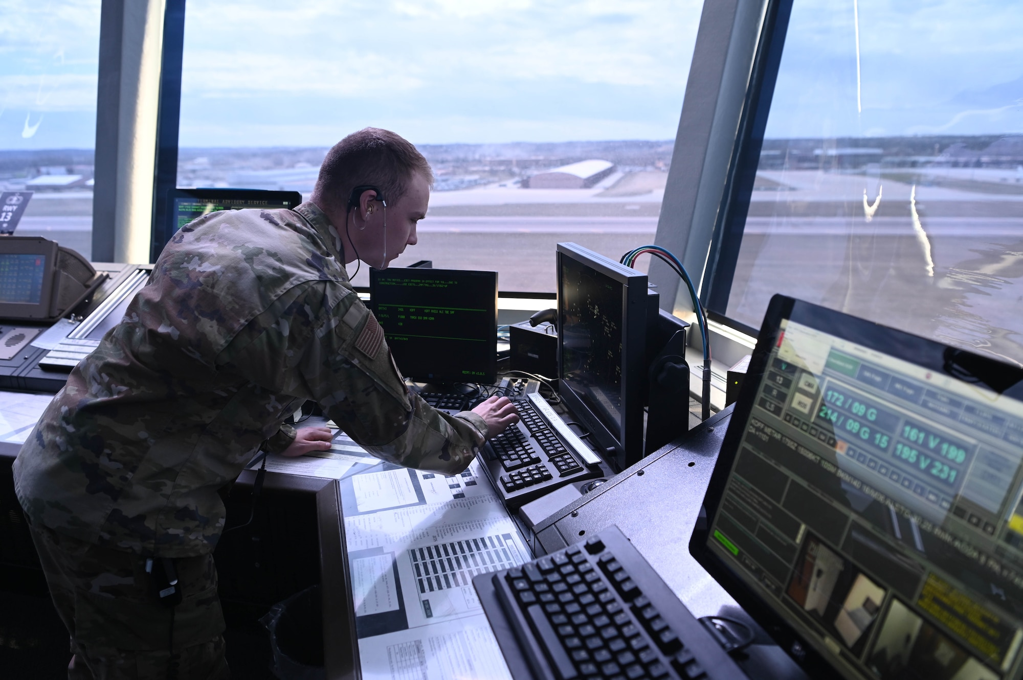 Senior Airman Daniel Mills, 55th Operations Support Squadron air traffic control trainer, views air traffic from the air traffic control tower cab March 26, 2025. Air traffic controllers ensure the airspace and airfield are safe for pilots to navigate to and from. (U.S. Air Force photo by Daniel Martinez)