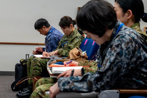 Attendees take notes.