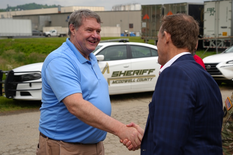 Acting Assistant Secretary of the Army for Civil Works E. Lee Forsgren (left), shakes hands with U.S. Senator Ted Budd at the Old Fort temporary debris management site in Old Fort, North Carolina, April 24, 2025. Both visited the TDMS to learn more about Hurricane Helene debris removal efforts across western North Carolina.