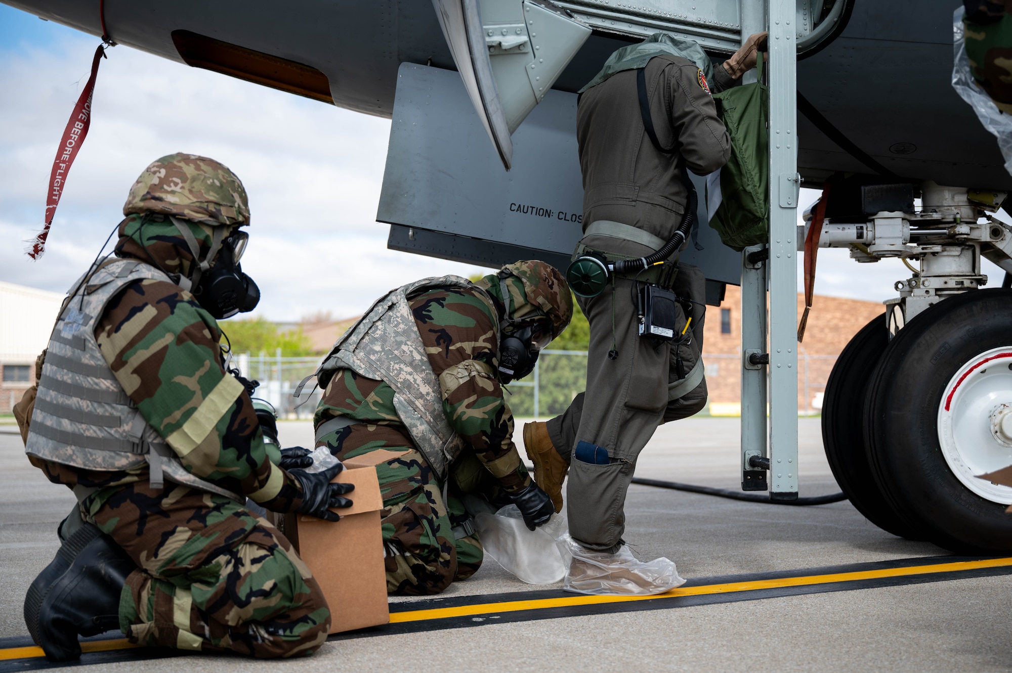 U.S. Air Force Airmen assigned to the 434th Air Refueling Wing, don protective gear during Exercise Hoosier Dawn