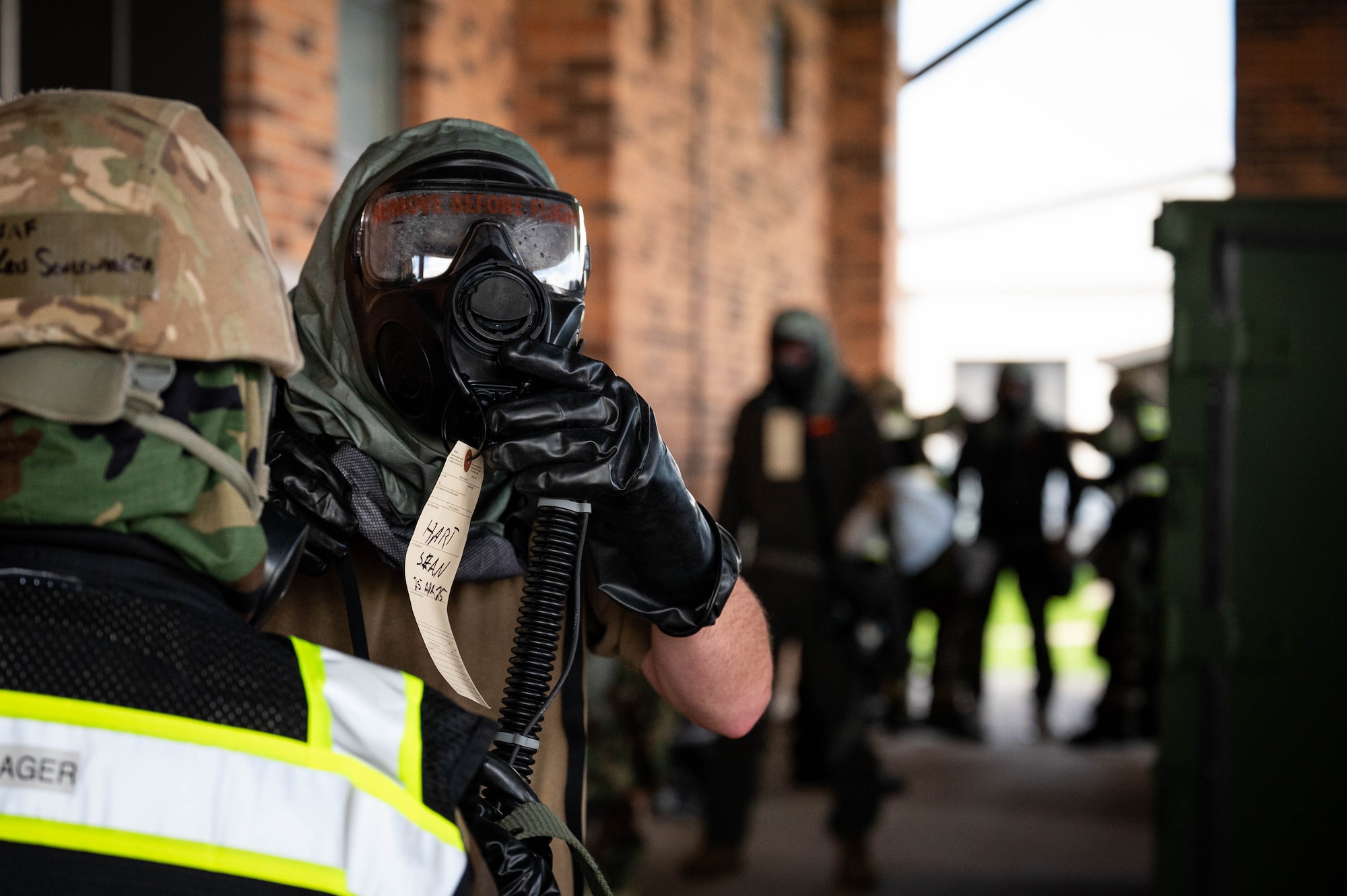 U.S. Air Force Captain Sean Hart, 74th Air Refueling Squadron pilot, removes his mask at a decontamination station during exercise Hoosier Dawn