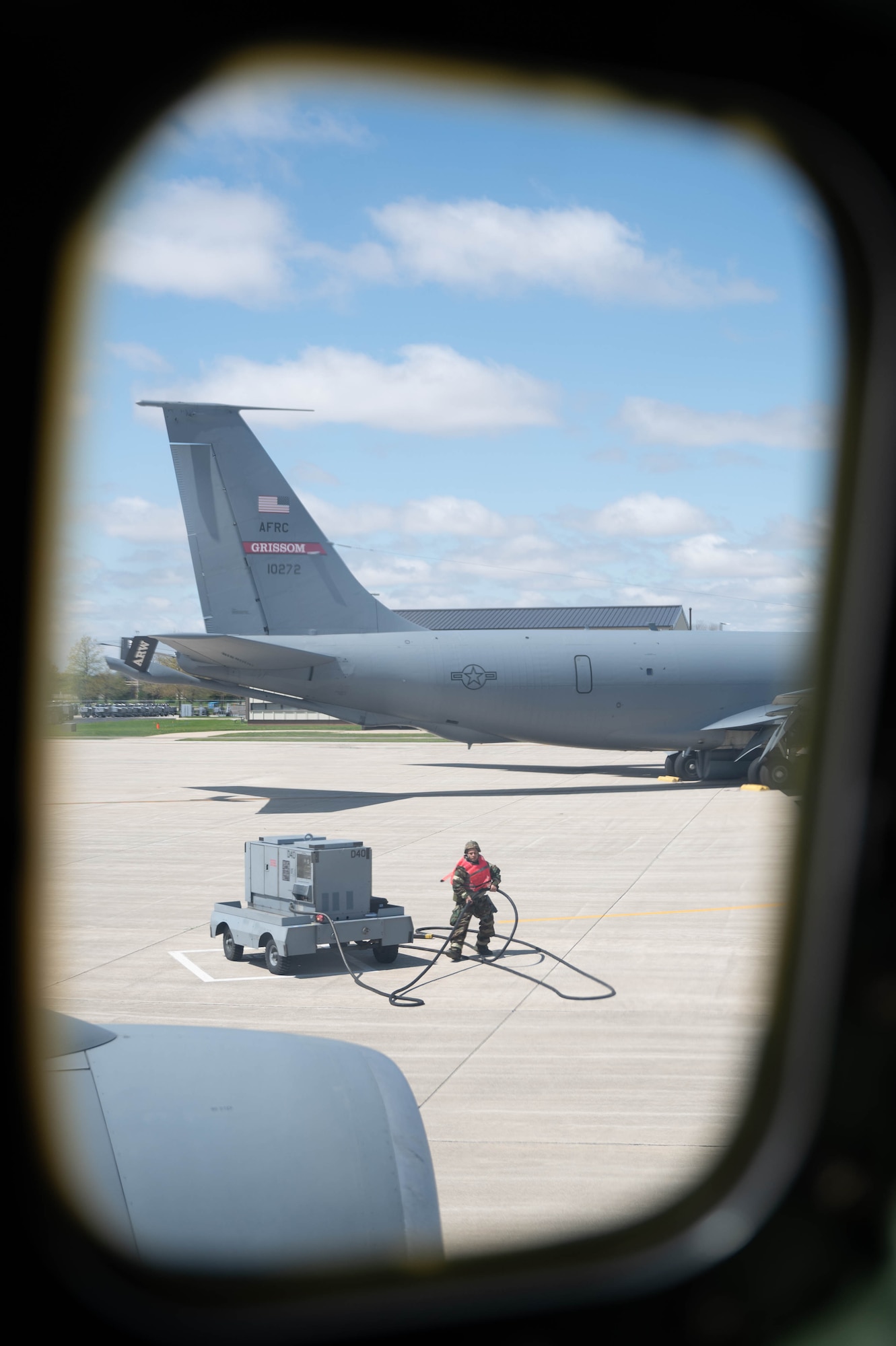 An Airman assigned to the 434th Air Refueling Wing gathers a cable as part of a pre-flight checklist