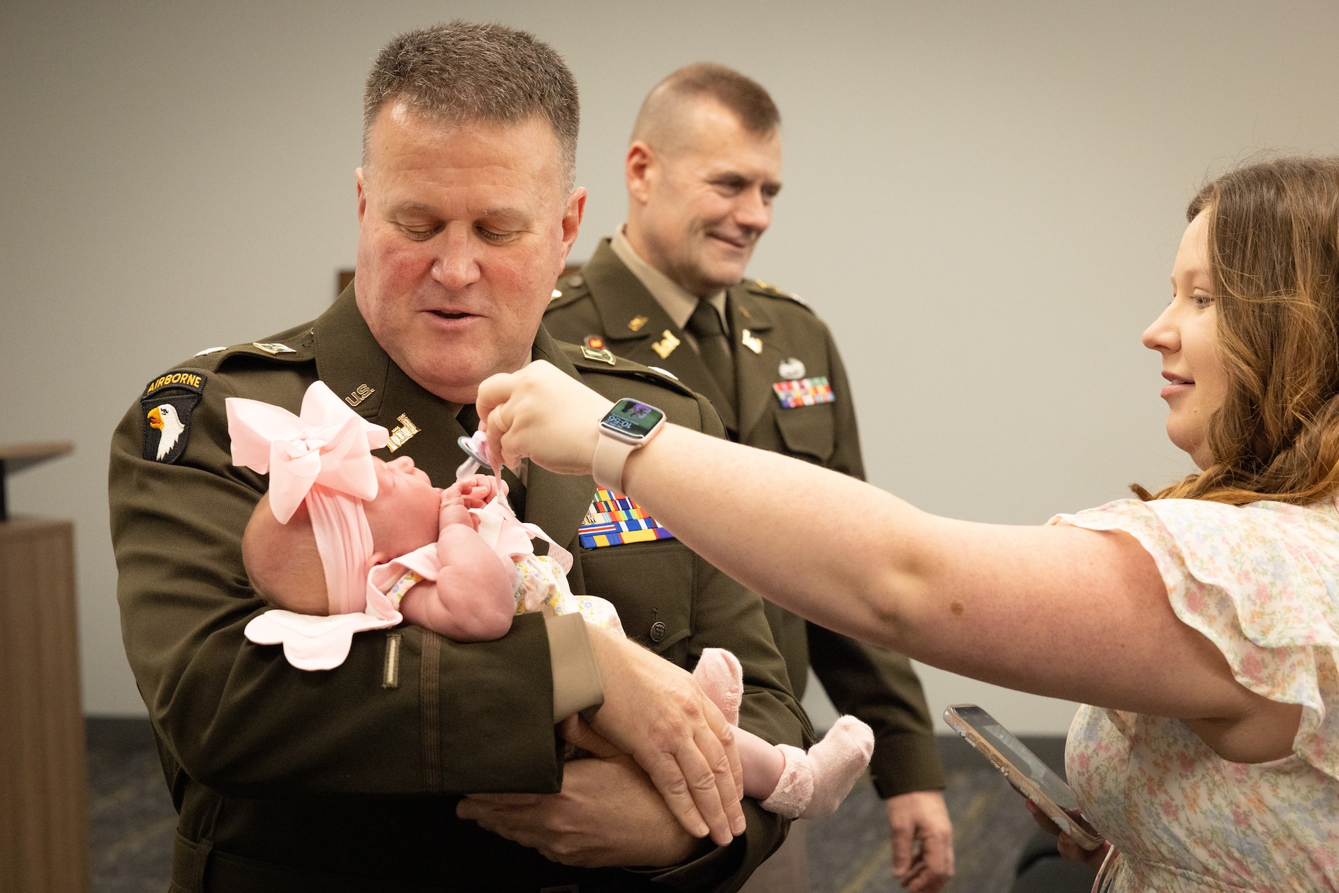 U.S. Army Lt. Col. Shannon Ison holds his granddaughter before his retirement ceremony at the Joint Forces Headquarters building on Boone National Guard Center in Frankfort, Ky. On April 18, 2025. Ison, a Silver Star recipient, retired after 22 years in a ceremony with friends and family present. (U.S. Army National Guard photo by Andy Dickson)