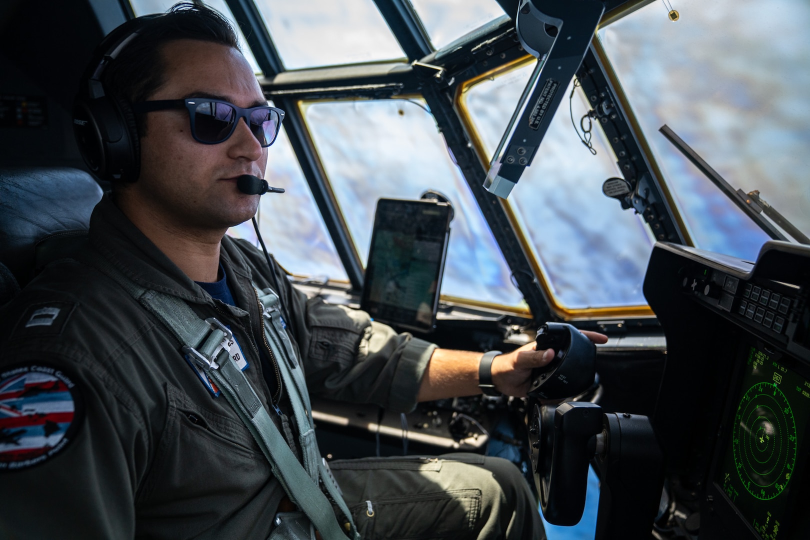 Coast Guard Lt. Camden Cecchini, a pilot assigned to Coast Guard Air Station Barbers Point in Kapolei, Hawaii, mans the controls of a Barbers Point HC-130 Hercules airplane during a training flight offshore Oahu April 24, 2025. The Coast Guard utilizes the HC-130 to support missions such as search and rescue, and maritime law enforcement. (U.S. Coast Guard photo by Petty Officer 2nd Class Tyler Robertson)
