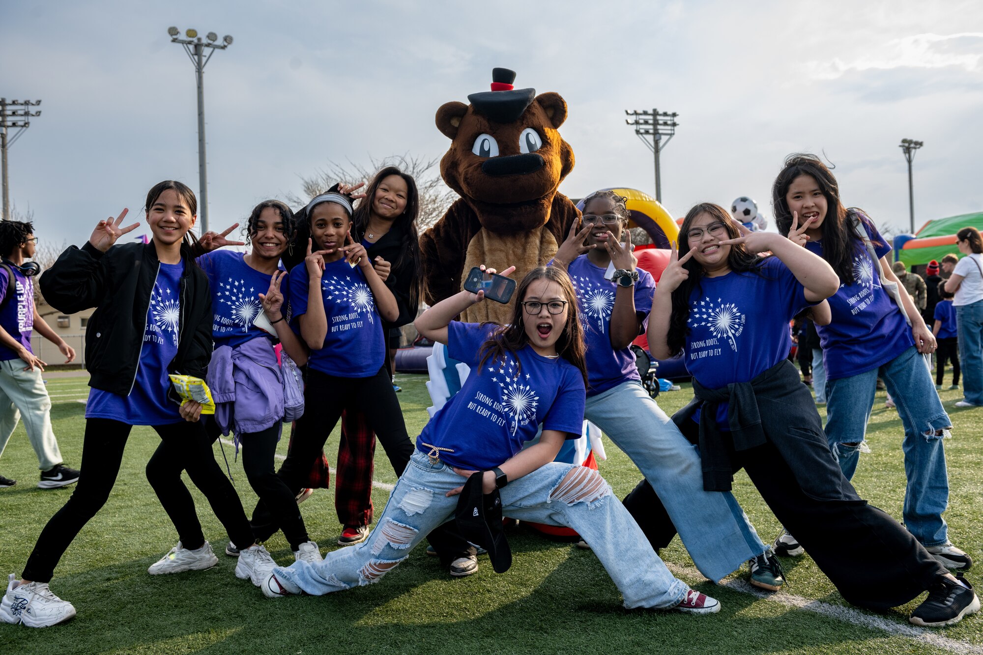 Participants pose with mascot.