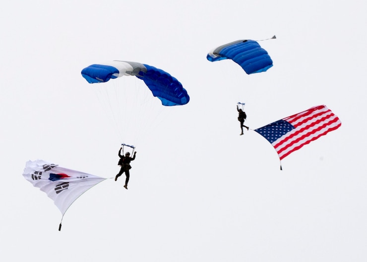 Members of the Republic of Korea Air Force high-altitude low-opening (HALO) jump team present the flags during the opening ceremony of Osan Air Power Day Sept. 21, 2019, at Osan Air Base, Republic of Korea. The event celebrates the US-ROK alliance and features aerial performances, static displays and a multitude of festivities. (U.S. Air Force photo by Staff Sgt. Ramon A. Adelan)