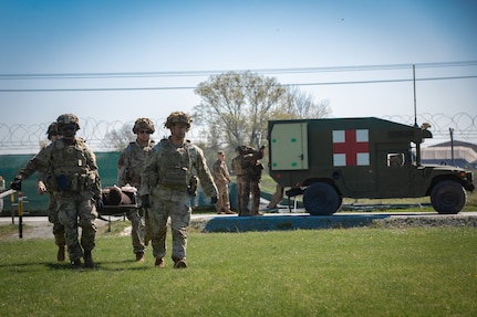 U.S. Army Soldiers assigned to 526 Brigade Support Battalion, 2nd Brigade Combat Team, 101st Airborne Division (Air Assault), carry a simulated casualty with a litter during a mass casualty exercise on Mihail Kogălniceanu Air Base, Romania, April 22, 2025. This exercise had U.S. Soldiers and NATO partners demonstrate their ability to rapidly adapt, communicate and support casualties during a crisis scenario, enhancing interoperability and readiness. (U.S. Army photo by Pfc. Nathan Arellano Tlaczani)