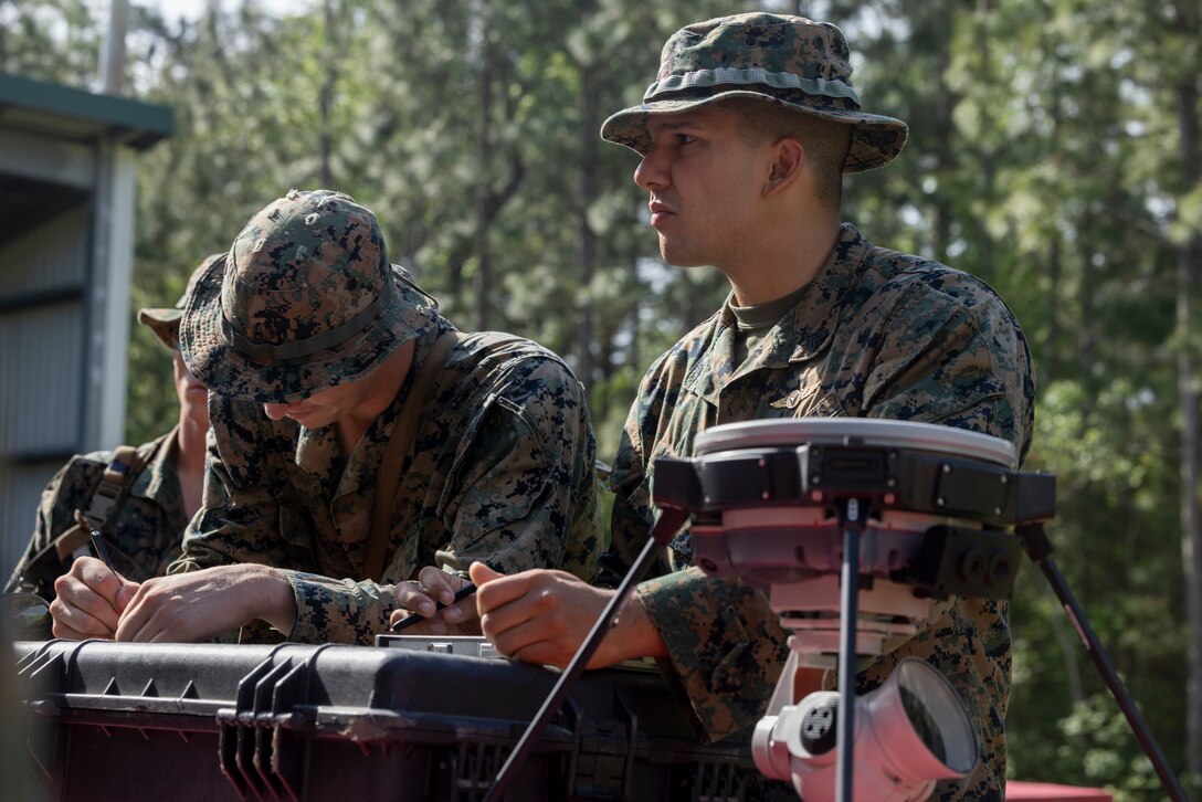 U.S. Marine Corps Sgt. Juan P. Afanador, right, an engineer equipment operator, and Cpl. Mathew J. Lunday, a combat engineer, both with 2d Combat Engineer Battalion, take notes during the 2d CEB Extended Use Exercise on Marine Corps Base Camp Lejeune, North Carolina, April 22, 2025. The purpose of the EUE is to evaluate developing technologies in the combat engineer field, specifically for the explosive hazard defeat realm. (U.S. Marine Corps photo by Lance Cpl. Alexandria Serrano)