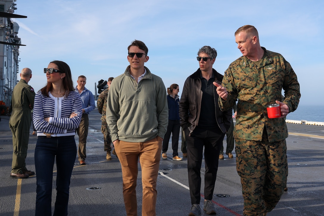 U.S. Marine Corps Col. Thomas N. Trimble, right, Commanding Officer, 22nd Marine Expeditionary Unit conversates with staff delegates while conducting a ship tour aboard the Wasp-class amphibious assault ship USS Iwo Jima (LHD 7), Iwo Jima Amphibious Readiness Group, during a staff delegation visit while underway in the Atlantic Ocean, April 5, 2025. The visit showcased the capabilities of the embarked 22nd Marine Expeditionary Unit as part of the IWOARG/22MEU team, illustrating the strategic importance of amphibious shipping for projecting power and rapidly responding to global crises. The delegation's visit aboard LHD 7 during Amphibious Squadron 8 (PHIBRON 8), 22nd MEU Integration (PMINT) exercise enabled dialogue between the staff members and Navy and Marine Corps personnel, deepening their understanding of the ARG/MEU's diverse mission sets and underscoring their indispensable role in achieving national security objectives. (U.S. Marine Corps photo by Cpl. Sharon Ruiz)