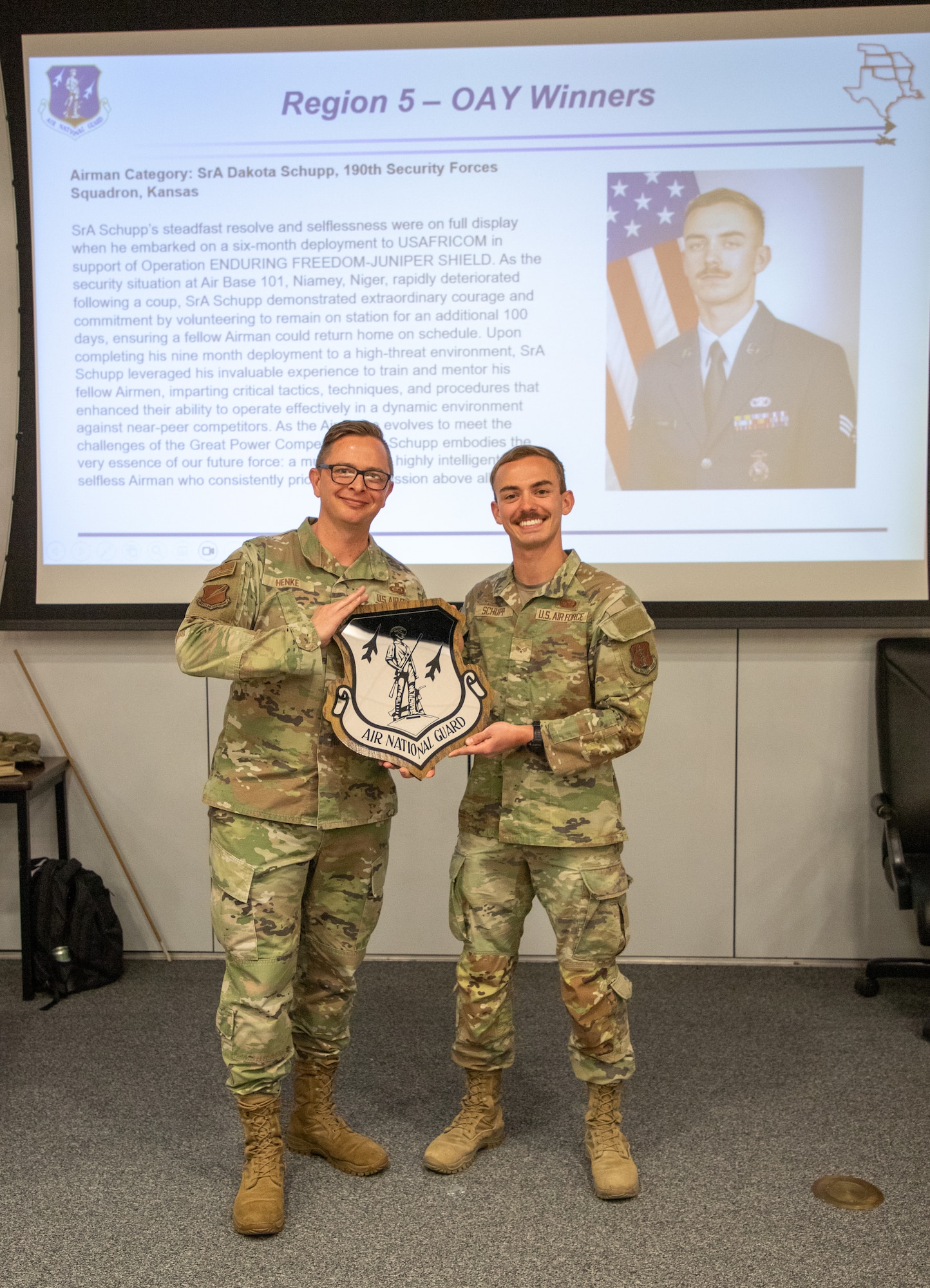 U.S. Air National Guard Senior Airman Dakota Schupp, 190th Air Refueling Wing,  poses with a plaque at Rosecrans Air National Guard Base